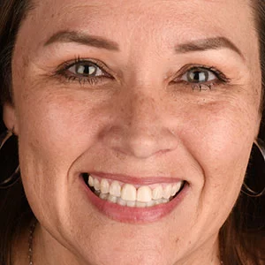 Smiling patient shown by Walden Dental